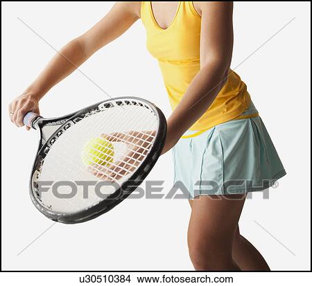 Picture - Young woman playing tennis. Fotosearch