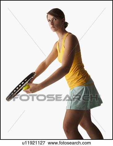 Stock Photo - Young woman playing tennis. Fotosearch