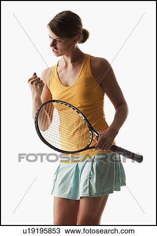 Stock Image - Young woman playing tennis winning. Fotosearch