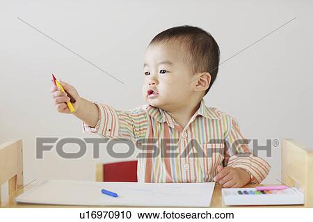 Stock Image - A boy drawing. Fotosearch