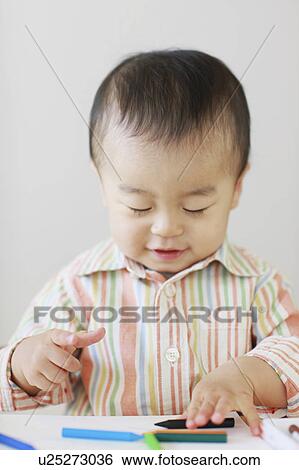 Stock Photograph - A boy drawing. Fotosearch