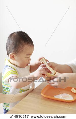 A boy eating bread View Large Photo Image Stock Photo - A boy eating bread. Fotosearch