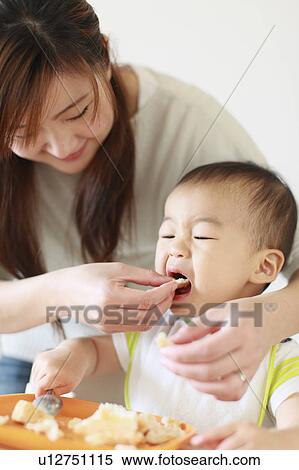 Stock Photography - A boy eating bread. Fotosearch