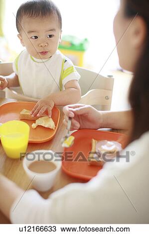 A boy eating breakfast View Large Photo Image Stock Image - A boy eating breakfast. Fotosearch