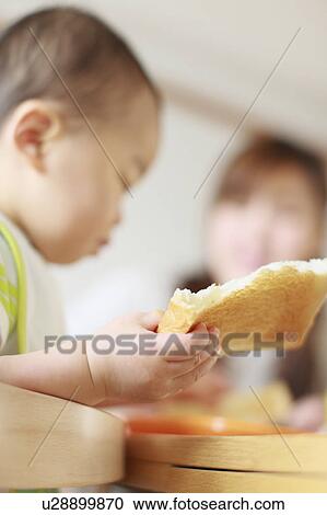 Stock Image - A boy eating breakfast. Fotosearch