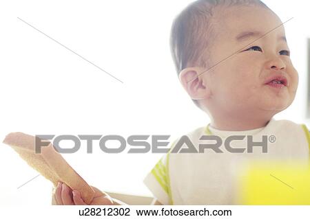 A boy holding bread View Large Photo Image Stock Image - A boy holding bread. Fotosearch