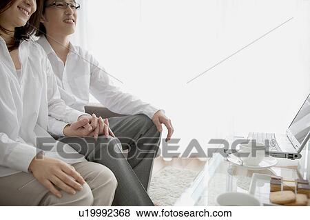 A couple holding hands View Large Photo Image Stock Photo - A couple holding hands. Fotosearch