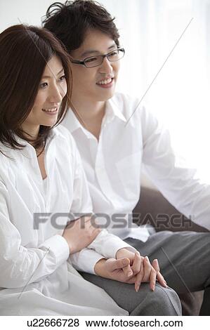 Stock Photo - A couple holding hands. Fotosearch