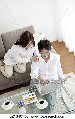 A couple using PC View Large Photo Image Stock Photo - A couple using PC. Fotosearch