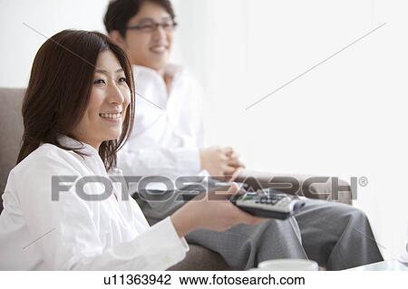 A couple watching TV View Large Photo Image Stock Image - A couple watching TV. Fotosearch