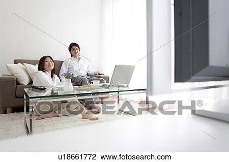 Stock Image - A couple watching TV. Fotosearch