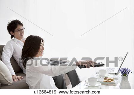 A couple watching TV View Large Photo Image Stock Photo - A couple watching TV. Fotosearch
