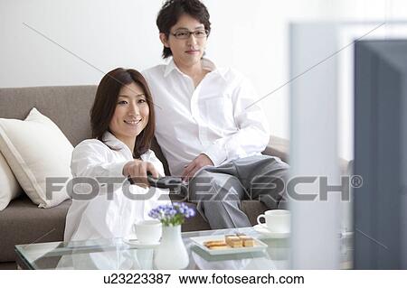 Stock Photo - A couple watching TV. Fotosearch