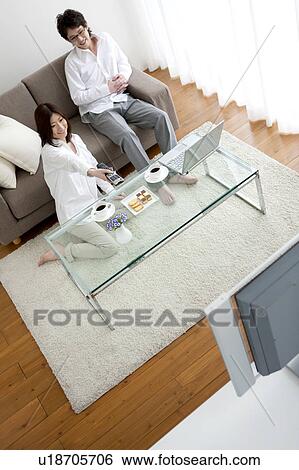 Stock Photograph - A couple watching TV. Fotosearch