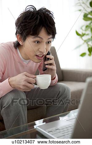 Stock Photo - A man talking on the cell phone. Fotosearch