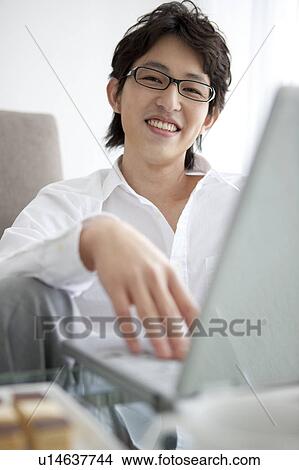 Picture - A man using PC. Fotosearch