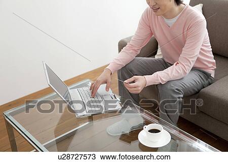 Stock Image - A man using PC. Fotosearch