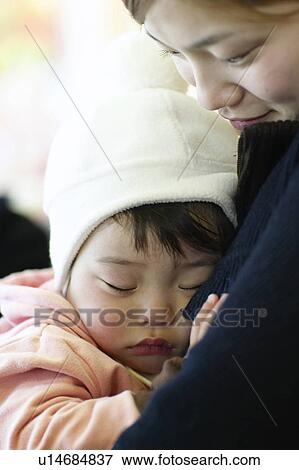 Baby Girl Sleeping in Mother's Lap View Large Photo Image Stock Photo - Baby Girl Sleeping in Mother's Lap. Fotosearch