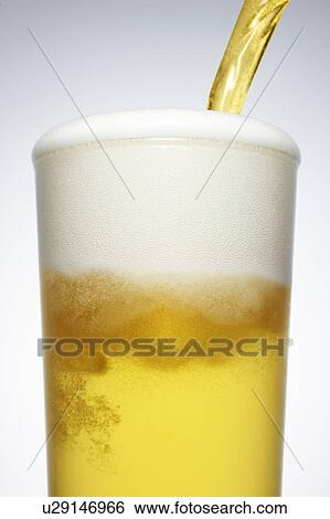 Stock Photograph - Beer Being Poured. Fotosearch