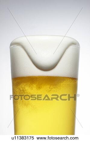 Stock Photography - Beer Spilling Over Pint Glass. Fotosearch