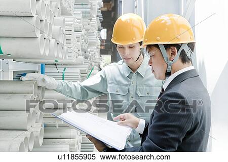 Stock Photography - Boss and Labourer at Warehouse. Fotosearch
