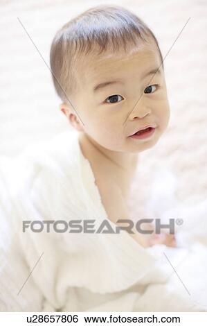 Stock Photograph - Boy Crawling Looking At Camera Towel Shirtless. Fotosearch