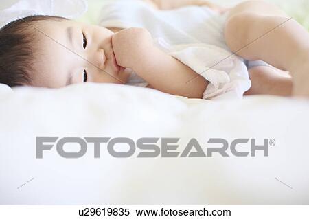 Stock Photography - Boy Lying On Side Thumb Sucking. Fotosearch