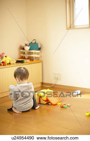 Boy Sitting Hardwood Floor Playing Toy View Large Photo Image Stock Image - Boy Sitting Hardwood Floor Playing Toy. Fotosearch