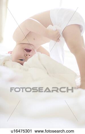 Stock Image - Boy Somersault Rolling Playing Shirtless. Fotosearch