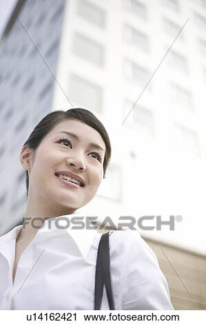 Stock Image - Businesswoman Smiling Outdoors. Fotosearch