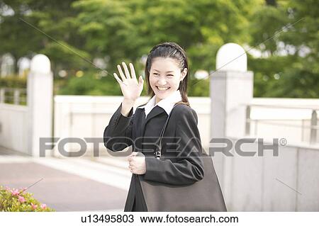 Stock Image - Businesswoman Waving Hand. Fotosearch