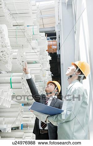 Stock Photo - CEO and Manual Laborer at Warehouse. Fotosearch