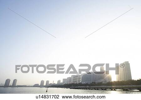 Stock Image - Cityscape Apartment Architecture Sea Sky Sun. Fotosearch
