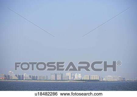 Stock Photograph - Clear Sky Over Buildings. Fotosearch