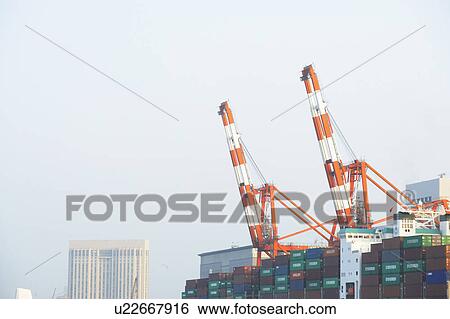 Stock Photograph - Commercial Dock Crane Architecture Sky Copy Space. Fotosearch