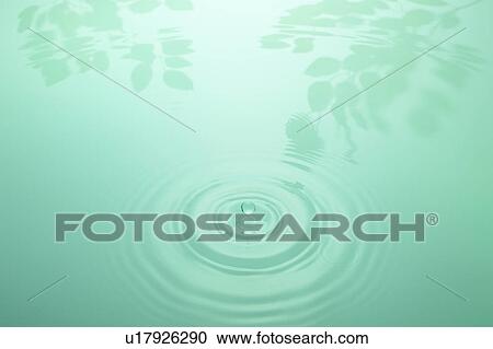 Stock Image - Droplet and Reflections on Water. Fotosearch