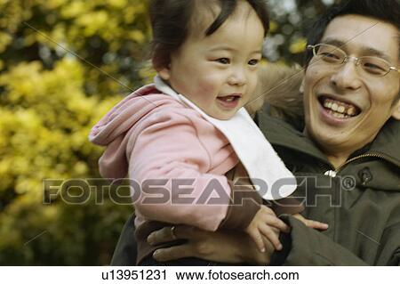 Father Carrying Baby Girl View Large Photo Image Stock Image - Father Carrying Baby Girl. Fotosearch