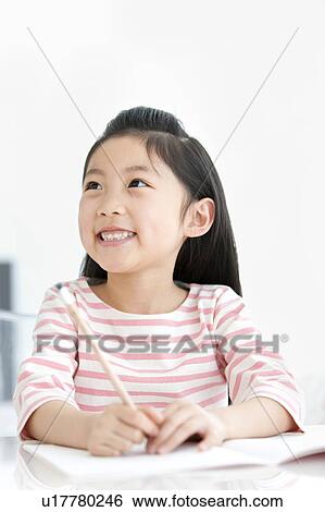 Stock Photograph - Girl doing homework. Fotosearch