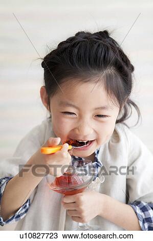 Stock Image - Girl eating jello. Fotosearch