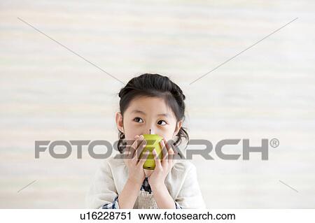 Girl holding an apple View Large Photo Image Stock Image - Girl holding an apple. Fotosearch