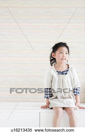 Stock Photography - Girl sitting on bench. Fotosearch