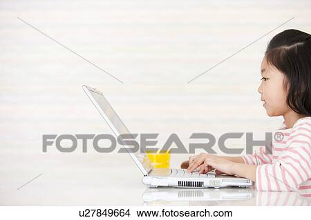 Picture - Girl using a laptop. Fotosearch