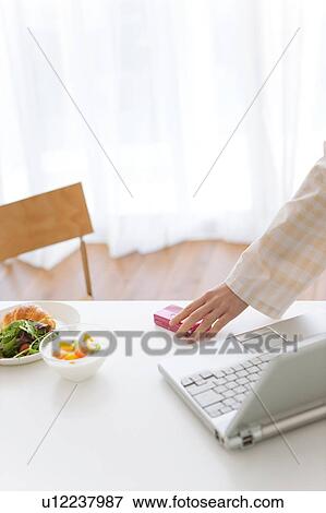 Stock Photo - Hand holding a cell phone. Fotosearch
