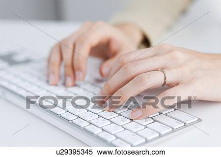 Stock Photography - Hands of woman using computer keyboard. Fotosearch