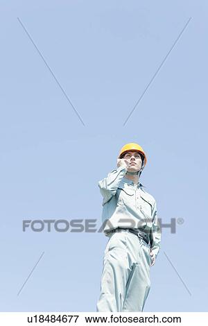 Stock Photo - Male Worker on Phone. Fotosearch