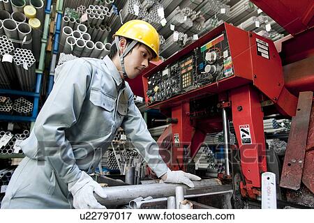 Stock Photo - Man Operating Machinery. Fotosearch