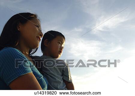 Stock Image - Mother and Child Against Sky. Fotosearch