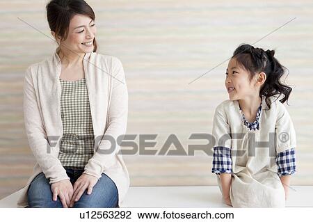 Stock Image - Mother and daughter looking at each other. Fotosearch
