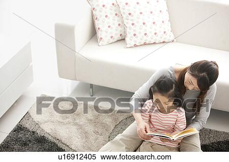 Mother and daughter reading a book together View Large Photo Image Stock Photography - Mother and daughter reading a book together. Fotosearch