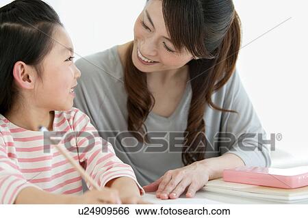 Mother and daughter studying together View Large Photo Image Stock Photograph - Mother and daughter studying together. Fotosearch